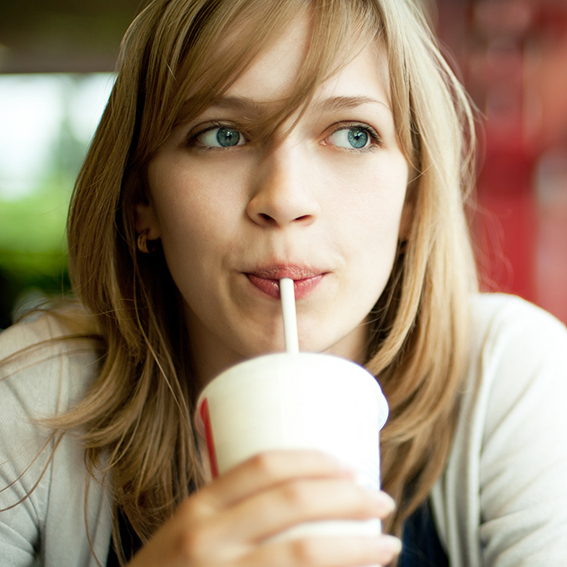 Woman drinking water out of a paper cup