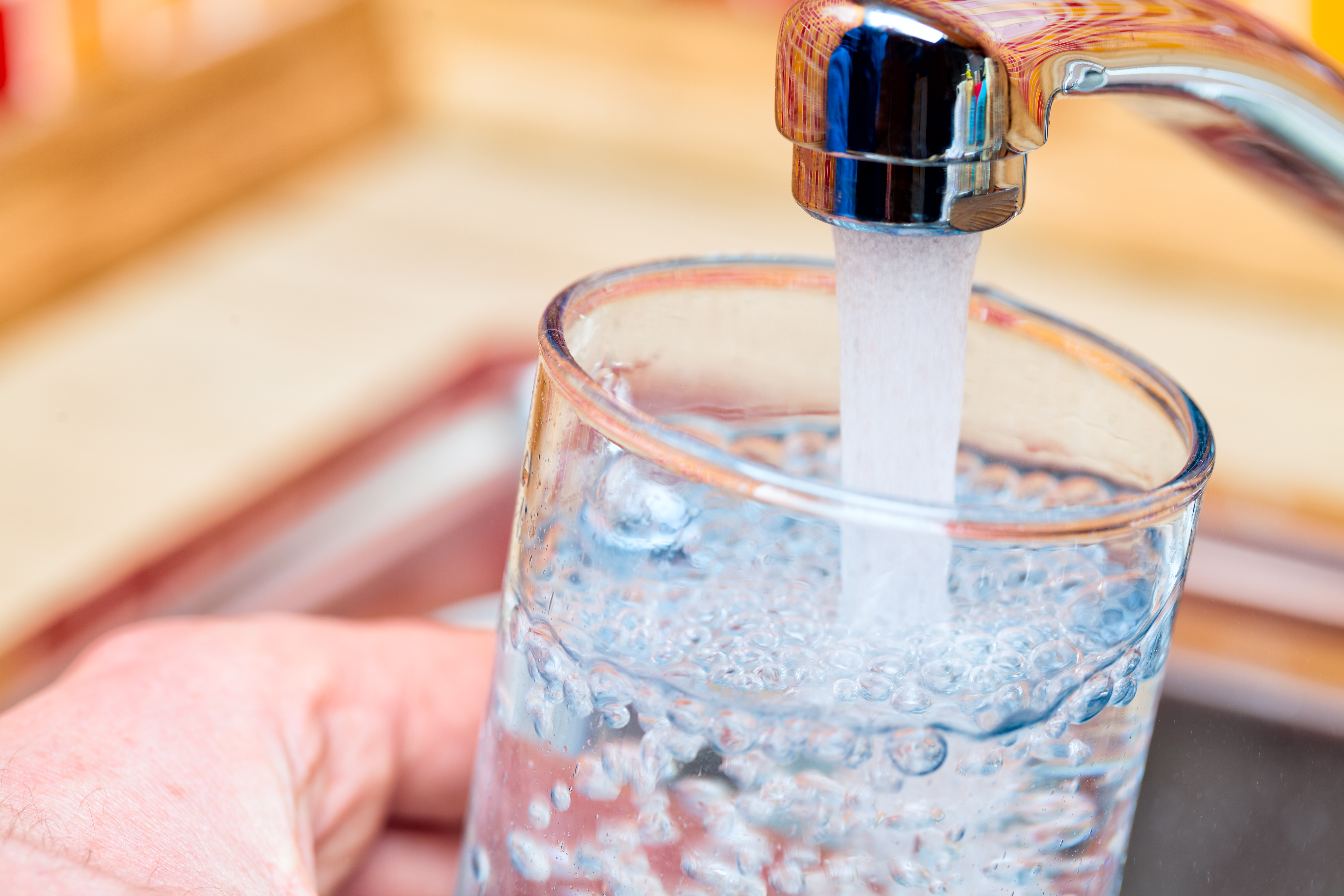 pouring tap water into a glass