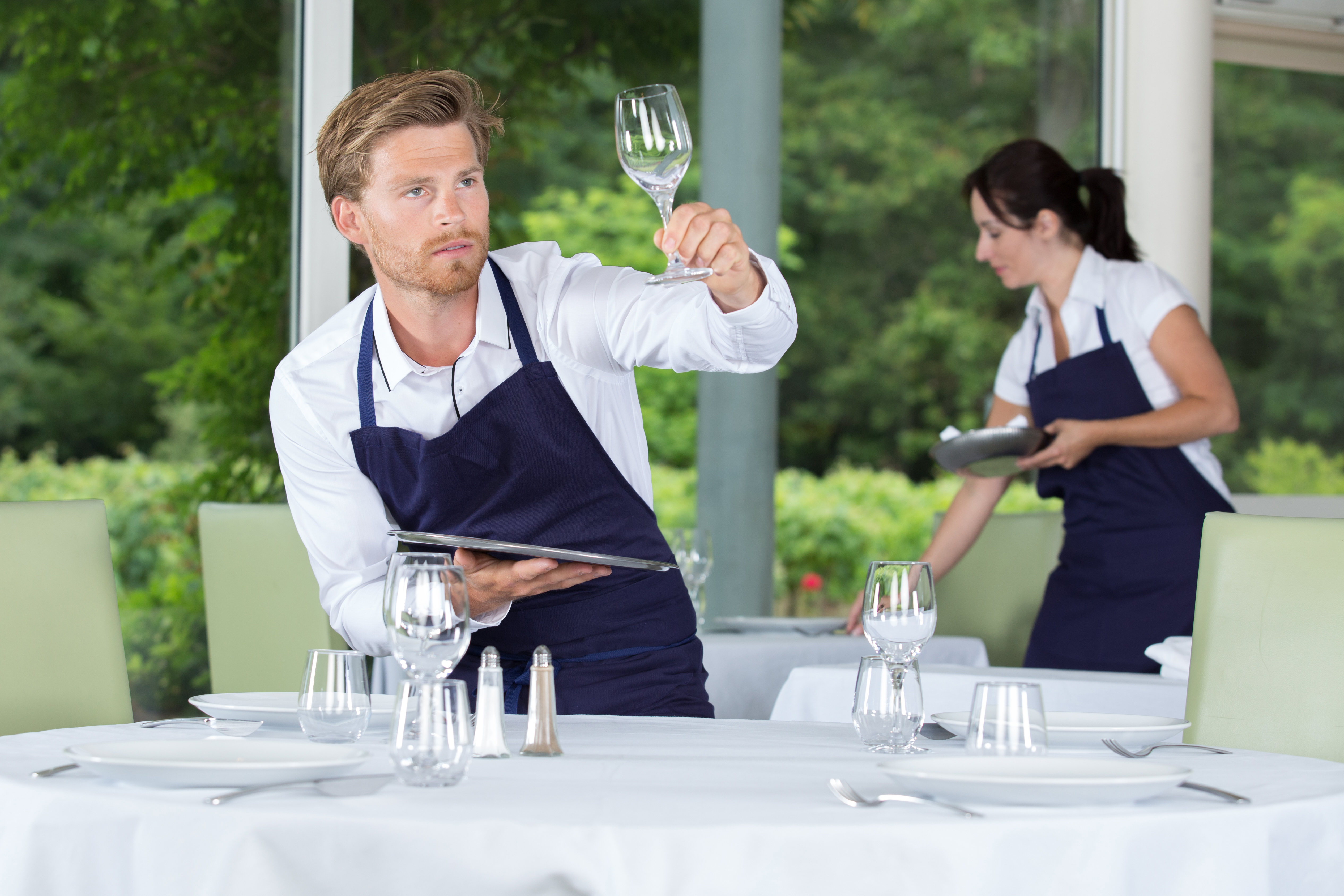 man inspecting a glass