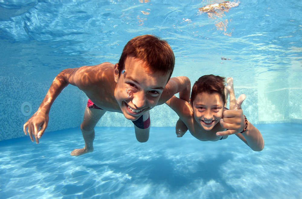 kids underwater in a pool