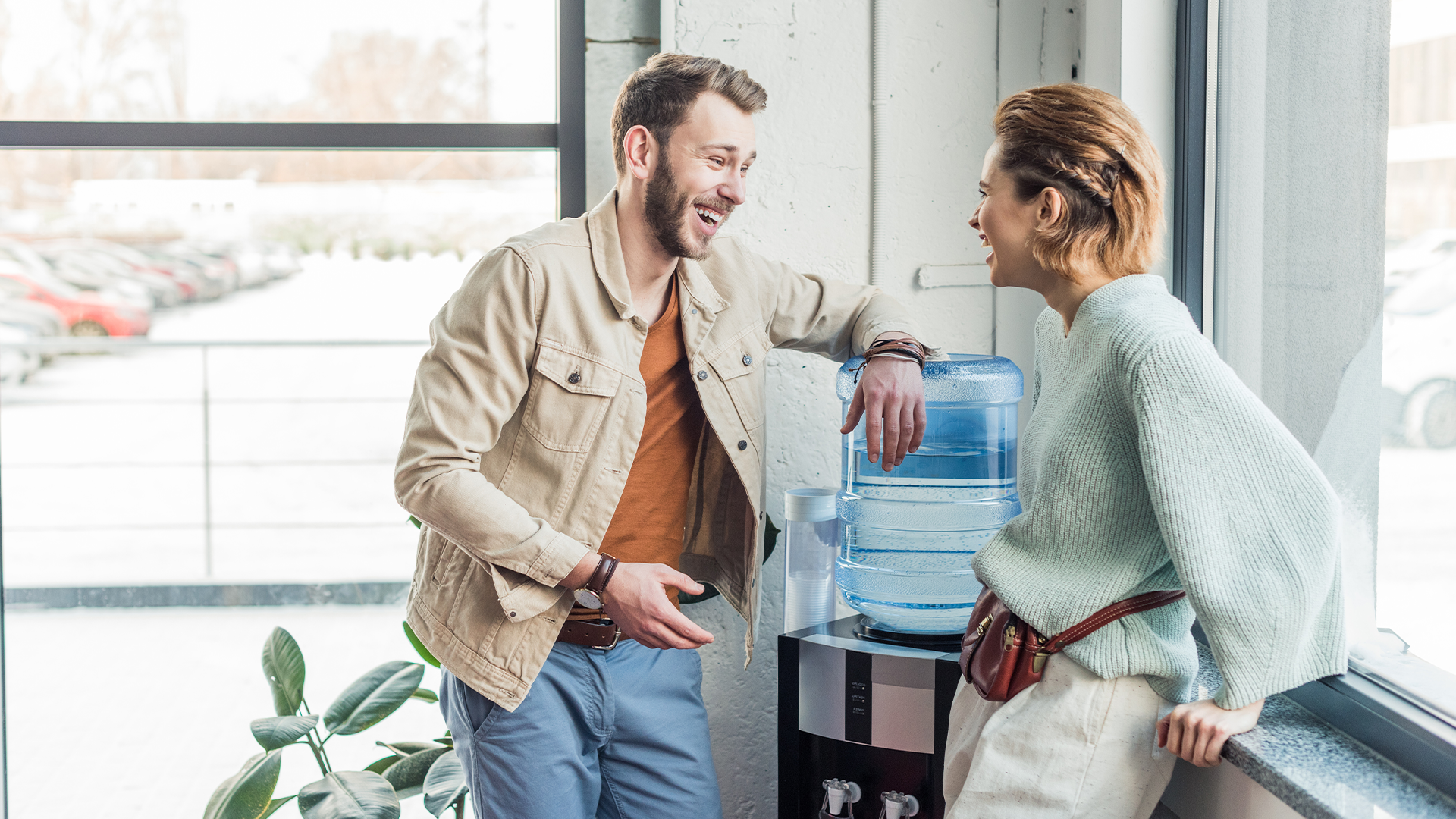 coworkers chatting at the water fountain