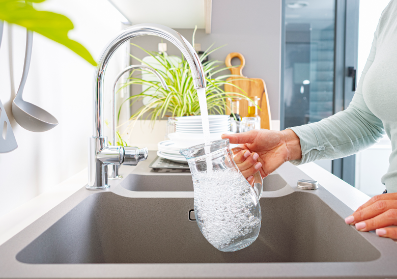 woman pouring tap water