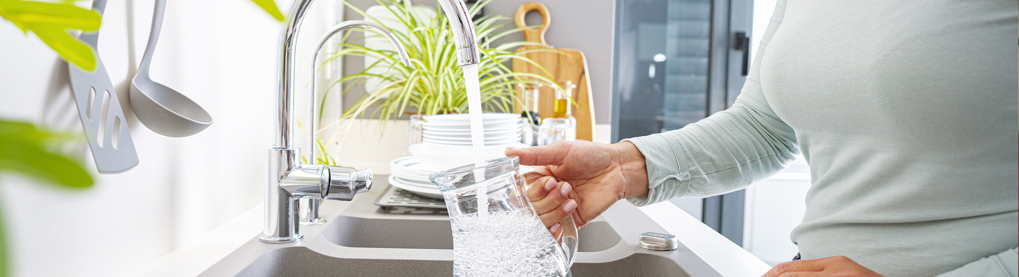 woman pouring tap water